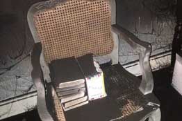 A chair and books post smoke damage